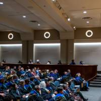 Faculty sit in the auditorium